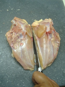 Cut along the line where the breastbone was to separate the breasts.